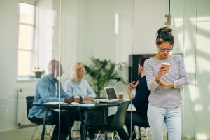 Young Asian businesswoman drinking a coffee in an office