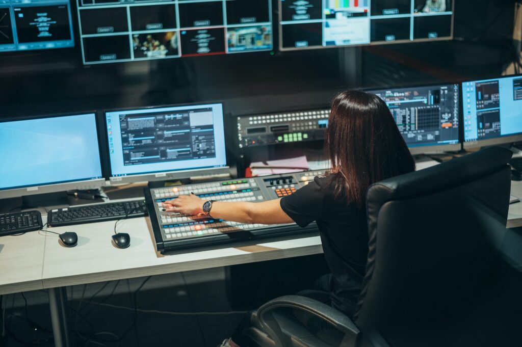 Young beautiful woman working in a broadcast control room on a tv station